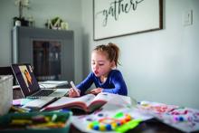 A girl participates in an online school session from home.