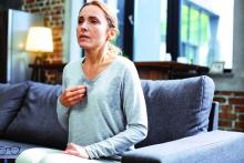 Mature woman resting on sofa and having hot flash.