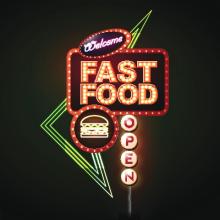 Fast food neon sign on black background.