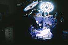 A surgeon operates on a patient