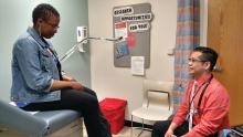 Dr. Gerald Montano, an adolescent medicine physician at UPMC Children's Hospital of Pittsburgh who works in the gender and sexual development program there, talks with a patient.