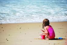 A female child playing in the sand at Misquamicut Beach, Rhode Island.