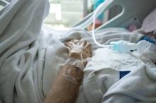 An elderly patient in a hospital bed