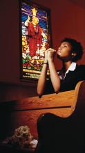 Boy praying in church