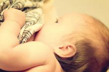 A baby breastfeeds