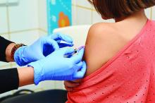 A young girl receives a vaccine in a doctor's office