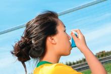 A girl using an asthma inhaler.