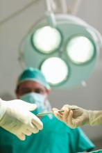 A supervising doctor in an surgical suite is shown