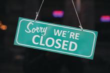 A &amp;quot;sorry we're closed&amp;quot; sign hanging outside of a business.