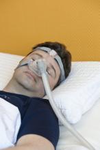 A man sleeping with a CPAP device