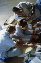 College students studying, using a laptop, and smartphone