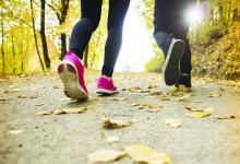 A closeup of the feet of two individuals running for exercise