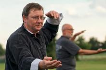 tai chi being done by adults outdoors