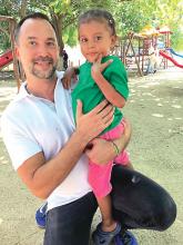 Dr. Ignacio Muñoz-Sanjuán poses with a child from an affected community in northern Colombia in 2017.