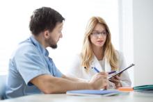 Two doctors discuss a patient's chart.