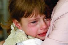 A young girl crying.