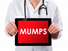 Doctor holding digital tablet with mumps written on the screen.