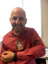 Dr. Arash Javanbakht with his research tarantula, Tony.