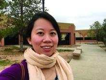 Dr. Lucinda Kohn in front of Chinle Hospital, where she provides dermatologic care.