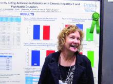 Anne Moore stands in front of her poster at the Liver Meeting.