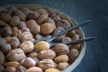 An assortment of tree nuts in a basket.