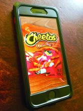 An Apple iPhone displaying Cheetos.