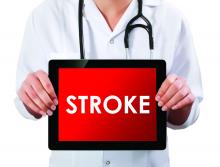 Doctor showing digital tablet with the saying stroke on the screen.