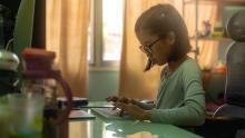 Elementary school student typing on keyboard