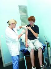 Teen male is shown receiving vaccination.