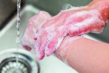 Woman washing her hands with soap