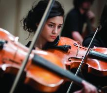 A woman plays a violin