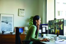 A woman particpates in a video conference from home