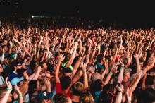 People raising their arms at a concert