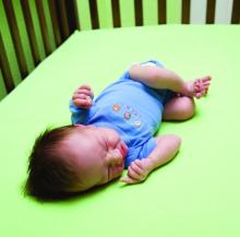 baby laying in crib looking agitated