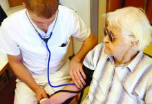 Elderly man gettting blood pressure taken