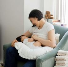 Asian woman breastfeeding her baby.