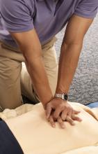 A man practices chest-compression CPR