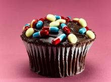 A picture of a cupcake covered with pills and tablets