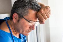 Concerned doctor looking through a window