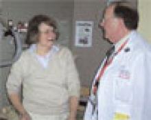 Dr. Reinstein consults with family member Sylvia Schechter. He sees five to six new patients each day in addition to following up with four to five patients to check their progress and prepare them for discharge.