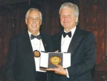 Dr. Vacanti, right, holding the award medallion, with Andrew Warshaw, MD, FACS, FRCSEd (Hon), ACS President. 