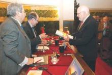 Caption: Dr. Pellegrini (right) receives his certificate from the Royal National Academy of Medicine of Spain. 