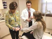 From left, rheumatologist Elinor Mody and rheumatologist-dermatologist Joseph F. Merola visit with a patient at the Center for Skin and Related Musculoskeletal Diseases, a combined clinic at Brigham and Women's Hospital in Boston.