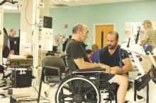 A stroke patient is assessed by his physical therapist.