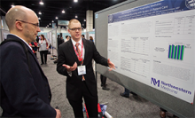 Brendan Sullivan, a second-year medical student at Midwestern University Chicago College of Osteopathic Medicine in Downers Grove, Ill., (right) discusses his poster, “Examining the Future of Hospitalist Medicine: Impact of Bedside Rounding with Nurses on Patient Care,” at HM15 with Mihai Gravis, MD, FHM, of ApolloMD in Richmond, Va.
