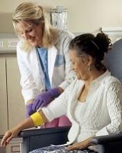 Nurse bandaging chemotherapy patient Photo by Rhoda Baer