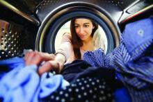 Woman removing laundry from dryer