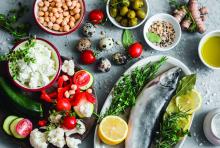 Mediterranean style food: Fish, vegetables, herbs, chickpeas, olives, and cheese