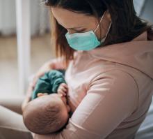 A mother holds her baby