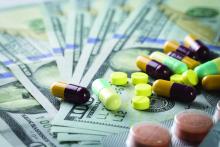 Pills and capsules atop a spread of $100 bills